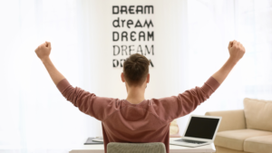 Freelancer sits with his arms outstretched facing 