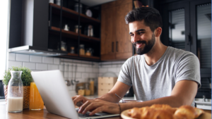 Freelancer works from their laptop in their kitchen. 